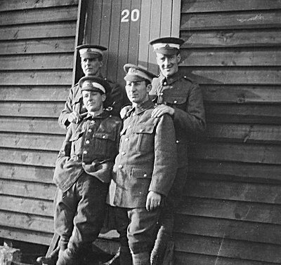 Flight Cadets at Denham in 1917 lean against one of the huts that made up the accomodation at the camp.