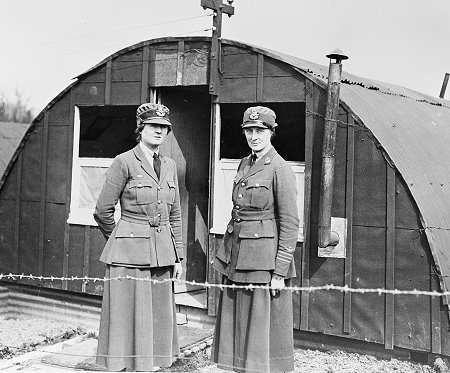 Two medical officers of the Womens Royal Air Force outside the later pattern hut that supplemented the earlier Army square huts