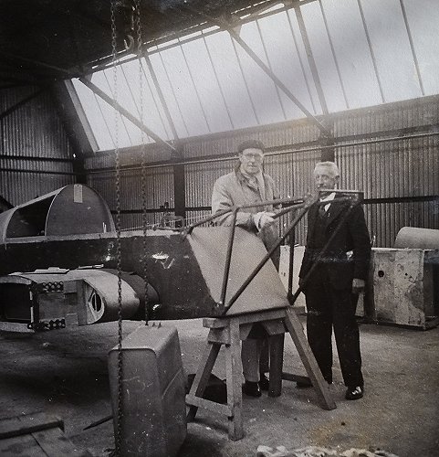 Myles Bickerton with Mr Hull, the Works Manager at Woodley, examining his M.2F Hawk Major under construction.