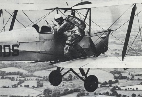 Major Willans in classic pose, aboard John Beadle's Tiger Moth over Fairoaks in 1952. Willans at the time was the Chairman of the British Parachute Club.