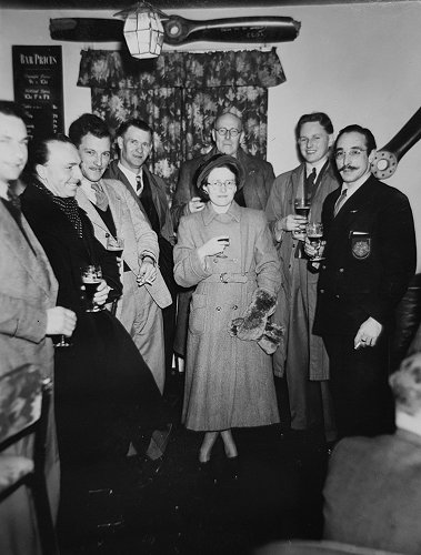 Eva Bickerton, centre, with her husband Myles at the Denham Flying Club. Famous British aviator and Auster test pilot Captain Ron Gillman is to the left of the group, Jimmy Millie, one of the founders of the club, is on the right.