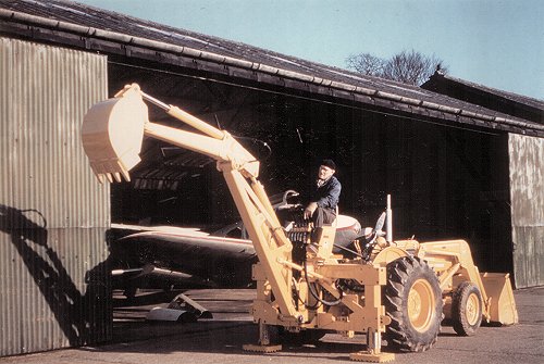 Myles Bickerton practices with the controls of the new Massey Ferguson tractor with its adaptable digger attachments.