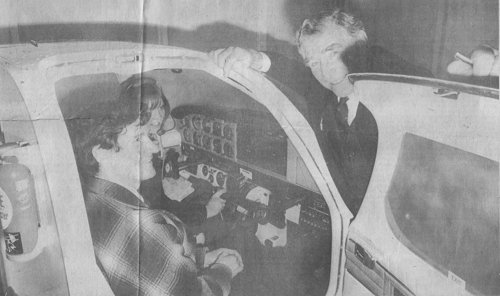 Tom Howard, owner of the Denham Flying Training School, chats to John Wilkinson and Judith Birch, seated in the school's flight simulator.