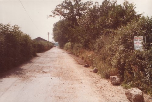 Looking along Hangar Road from the eastern end, past the hangars. The road was originally built to facilitate moving the hangars back onto the aerodrome at the end of the Second World War.