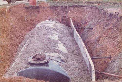 Once in position, the tank was filled with water to hold it down, and the task of encasing it in concrete and refilling the excavation could begin.