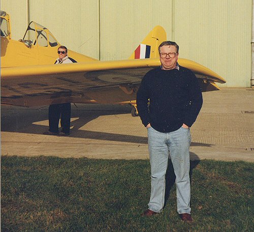 Richard Parker with his North American T.6 Harvard IIB. Denham-based flying instructor Graham Warnock is next to the cockpit.