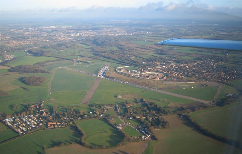 This is a view of Bovingdon disused aerodrome looking east. Hemel Hempstead is visible beyond.